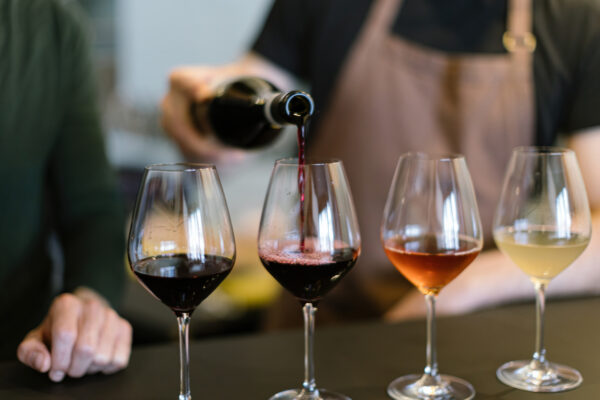 pouring different wines into the glasses for the wine tasting - The Beacon Inn